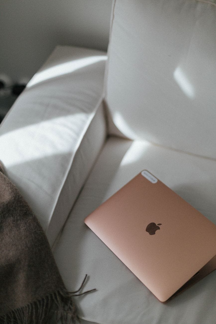 a laptop lying on a sofa