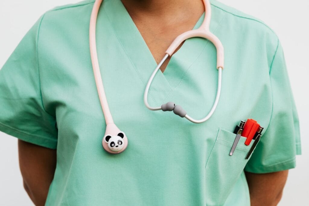 a doctor in a scrub suit with a stethoscope
